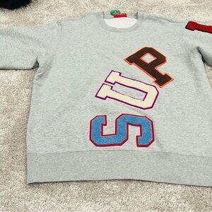 Supreme size medium men’s patchwork crew neck sweater